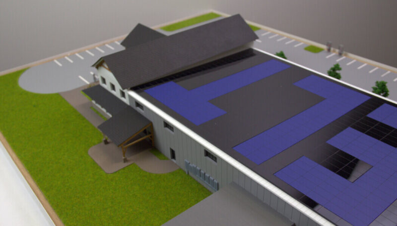miniature building with photovoltaic panels